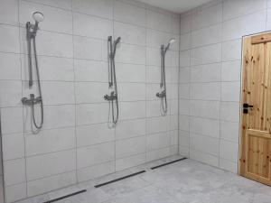 a bathroom with a shower with white tiles at Rybka living apartments in Přerov
