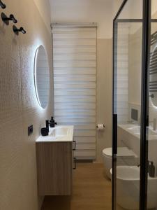 a bathroom with a sink and a toilet and a mirror at Masonber trastevere centro Wi-Fi free balcone metro in Rome