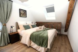 a bedroom with a bed and a window at chambresdusoleil in Hoffen