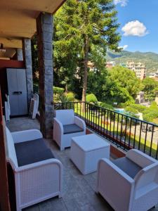 a patio with couches and chairs on a balcony at Residence Eurotel da Nella e Stefano in Rapallo