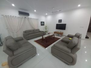 a living room with two couches and a television at DHA 2 Villa, Islamabad in Islamabad