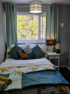 a bedroom with a bed in front of a window at Stylish and Comfortable Home in Beeston