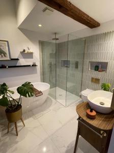 a bathroom with a tub and a toilet and a sink at City Penthouse with 3 floors , Super King Bed , with secret garden in Birmingham +21 photos