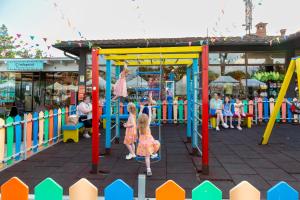 two children playing on a playground at an amusement park at hu Norcenni Girasole village in Figline Valdarno