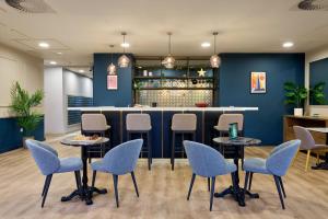 a restaurant with blue walls and chairs and a bar at For Students Only - Studio Rooms in Reading in Reading