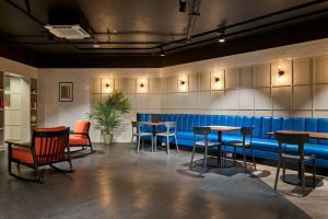 a restaurant with tables and chairs and a blue bench at For Students Only - Studio Rooms in Reading in Reading