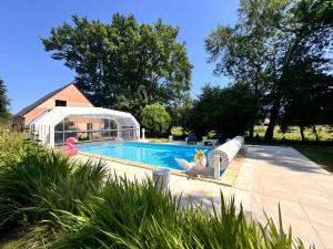 a swimming pool with toy flamingos in a backyard at Villa Nausicaa - Circuit des 24h du Mans - Piscine in Arnage