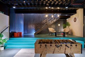 a room with a foosball table in the middle at For Students Only - Studio Rooms in Reading in Reading