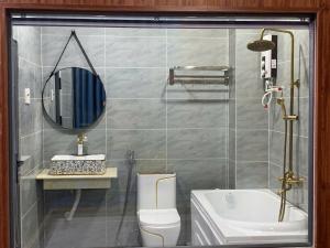 a bathroom with a shower and a toilet and a sink at royal hotel bà điểm hồ chi minh in Ho Chi Minh City