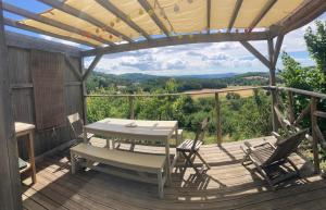 a patio with a table and chairs on a deck at L'escalette in Vernoux-en-Vivarais