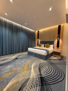 a hotel room with a bed and a carpet with arology at القصر المميز للأجنحه الفندقيه in Abha +22 photos