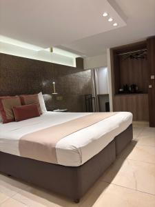 a bedroom with a large bed in a room at Tuck Inn in Larnaca