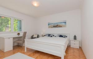 a white bedroom with a bed and a desk at Beautiful Villa Lara with sauna in Imotski in Kamenmost +64 photos