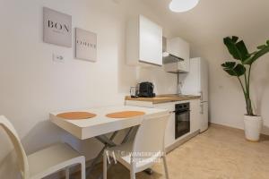 a kitchen with a table and chairs and a refrigerator at Wanderlust Experience Bea in Bitonto +17 photos