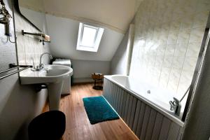 a bathroom with a sink and a bath tub at LA VALLÉE DU LAUNAY GiTES in Taden +73 photos
