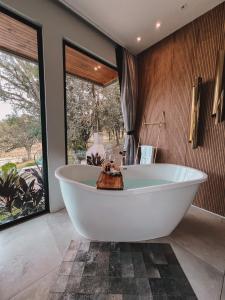 a bath tub in a bathroom with a large window at Cabana QUARTZO- Vista para PONTO TURISTIC0 Pedra Morro do Campestre- ACESSO até a cabana asfaltado in Urubici +47 photos