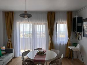 a living room with a table and a couch at Yaio Penthouse in Agigea