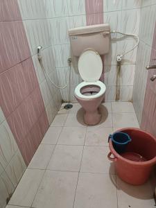 a bathroom with a toilet and a bucket in it at Lakshmi Narasimha Luxury PG for Gents in Bengaluru