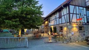 a building with a tree in front of it at Alte Pletschmühle in Homberg