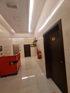 a hallway of a building with a exit sign on the door at اجنحه اسوار للشقق الفندقيه in Salalah