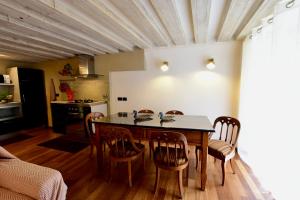a kitchen and dining room with a table and chairs at Luxury Cernaia Home alloggio di charme nel Centro Storico in Genoa +18 photos