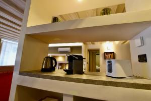 a kitchen with a microwave and a refrigerator on a counter at Luxury Cernaia Home alloggio di charme nel Centro Storico in Genoa