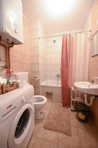 a bathroom with a washer and a toilet and a sink at Olja in Sarajevo +45 photos