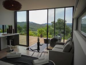 a living room with a lot of glass windows at Studio Blackk in Digne-les-Bains