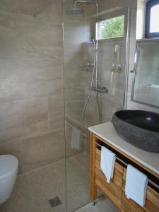 a bathroom with a sink and a glass shower at Studio Blackk in Digne-les-Bains