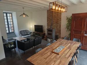 a living room with a wooden table and chairs at Grand gîte au coeur d'un charmant village in Miglos