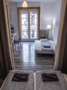 a hotel room with two beds and a balcony at Chic Asboth City Center Loft - Perfect Location in Budapest