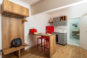 a kitchen with a counter and a red refrigerator at Luxury Fire Home - Catania in Catania