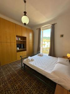 a bedroom with a bed and a large window at Vera Rosa Speziata, Cinque Terre in La Spezia +17 photos