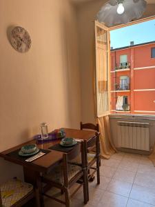 a dining room with a table and a window at Vera Rosa Speziata, Cinque Terre in La Spezia