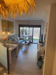 a living room with a blue couch and a table at Vacaciones Cambrils sol Park in Cambrils