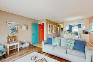 a living room with a couch and a kitchen at The Beach Escape in Clearwater Beach