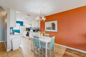 a kitchen with a white table and blue chairs at The Beach Escape in Clearwater Beach +20 photos