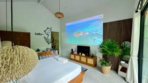 a bedroom with a bed and a large painting on the wall at Salad Beach Guest House in Ko Phangan +10 photos