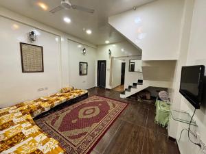 a living room with a couch and a tv at Alfiya Residency - Green Park in Indore