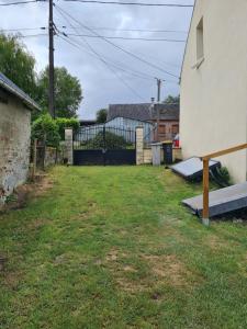 a backyard of a house with a fence at Le studio à la campagne in Saint-Gobert +8 photos