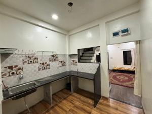 a kitchen with a sink and a counter top at Alfiya Residency - Green Park in Indore