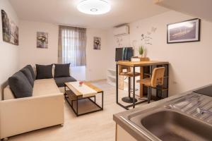 a living room with a couch and a table at Apartments Mihael in Baška