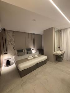 a bedroom with a large bed and a sink at Tuck Inn in Larnaca