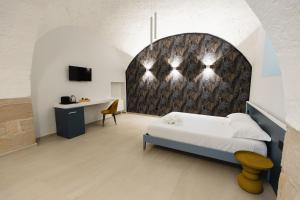 a bedroom with a bed and a wall at BeHome in Trani