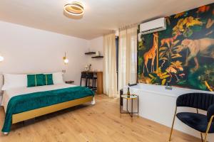 a bedroom with a bed and a painting of giraffes at Luxury Fire Home - Catania in Catania +84 photos