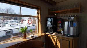 a room with a window and a desk with a refrigerator at Botel Clair d'Etoile in Amsterdam +19 photos