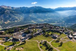an aerial view of a town in the mountains at Location Pra-Loup Vacances in Pra-Loup