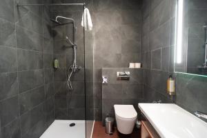 a bathroom with a shower and a toilet and a sink at Best Western Hotel Presov in Prešov +64 photos