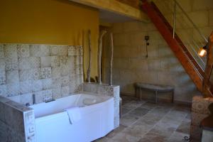 a bathroom with a bath tub in a room at Mas Petit Prince in Arles +44 photos