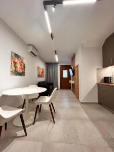 a kitchen and dining room with a table and chairs at Quince city center 3 in Heraklio